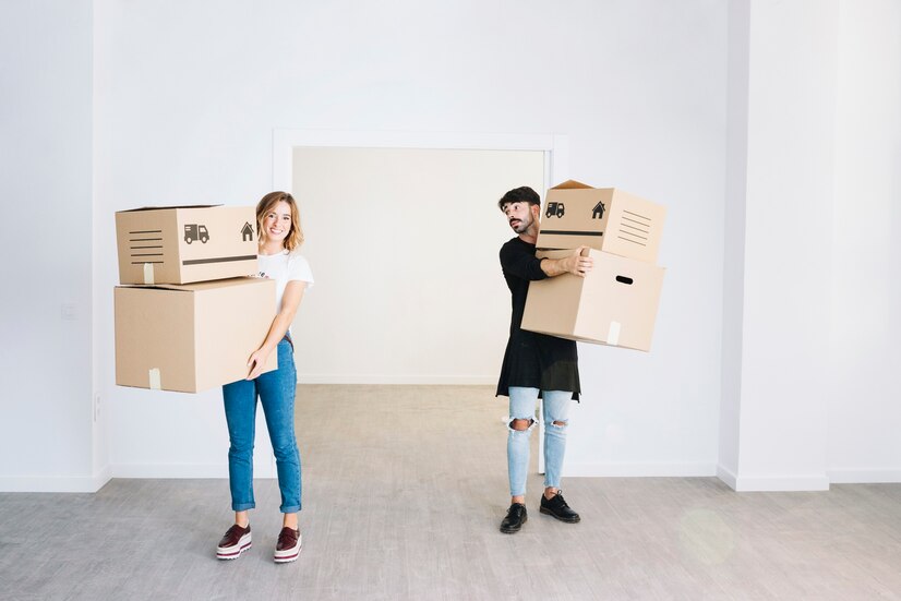 Couple holding boxes