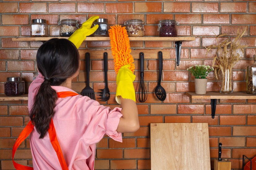 young-girl-is-wearing-yellow-gloves-while-cleaning-kichen-room-with-duster-her-house_1150-21776